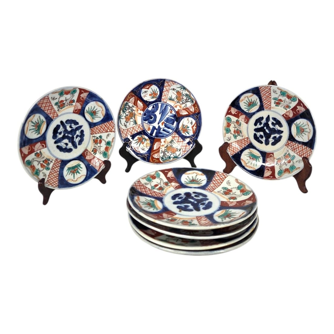 7 JAPANESE IMARI PORCELAIN PLATES: 7 Antique Japanese Imari porcelain plates. The plates feature alternating pie-shaped panels depicting garden scenes, foliage, and birds radiating outward from a center circular medallion. The signatur