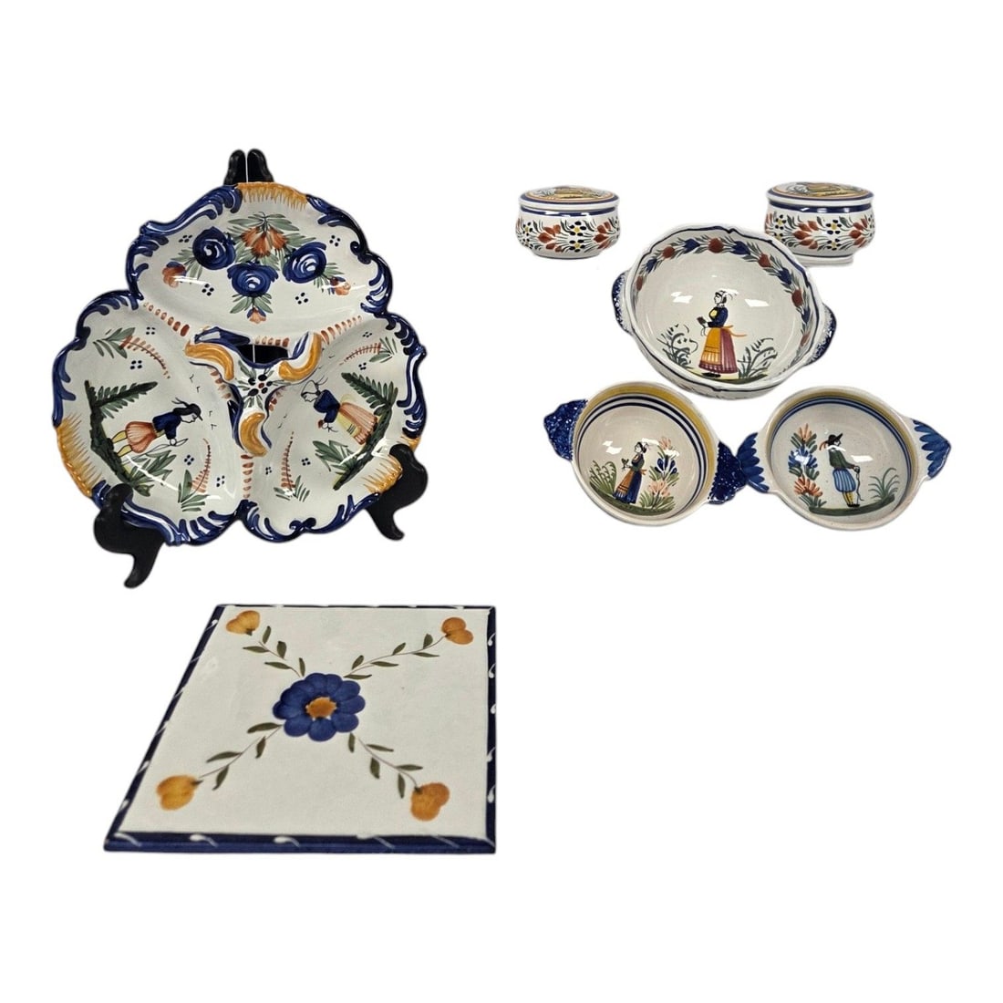 7 PC ASSORTMENT OF QUIMPER TABLEWARE: 7 piece lot of assorted Quimper tableware items including: 2 small bowls with handles measuring 2 H x 5.5 W, 1 single bowl 2.5 H x 6.5 W, 1 square tile (hot plate) 8 W, 2 trinket jars with lids 2 H x