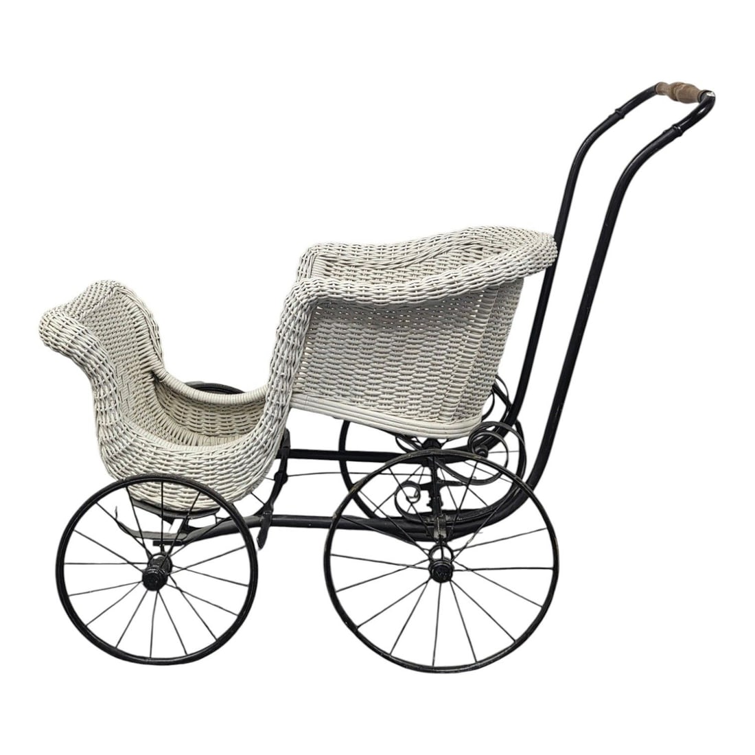 VINTAGE WHITE WICKER DOLL CARRIAGE: Vintage white wicker doll carriage featuring a woven basket seat, wire spoke metal wheels and a push handle with a wooden grip. Measures 35 H x 34 W x 21 D. Good condition, but some wear to the wood h