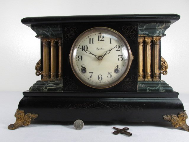 INGRAHAM METAL MOUNTED FAUX MARBLE MANTEL CLOCK: Ingraham metal mounted faux marble finished mantel clock. Enamel arabic numeral dial, convex glass crystal, and with metal mounted side handles and feet on clock case. Original movement. Condition: mi
