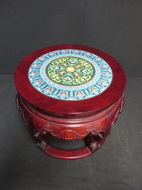 CHINESE CLOISONNE & ROSEWOOD STOOL OR BENCH: Chinese Cloisonne and carved Rosewood stool or bench. Colorful 12.25" cloisonne surface, with a carved Rosewood base. Measures a total of 17.75" wide x 13.5" tall. Total weight: 15 lbs.