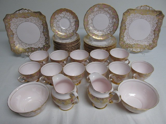 TUSCAN ENGLISH BONE CHINA DINNERWARE: 41 PCS: Tuscan English bone china dinnerware in a pink floral pattern. Includes (11) 4.3" wide cups, (12) 5.5" saucers, (12) 7" plates, (2) 5" wide bowls, (2) 4.25" tall creamers, and (2) 9.25" wide trays. Ea