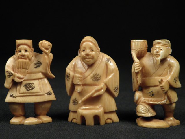 THREE JAPANESE CARVED IVORY NETSUKE: Lot of three Japanese carved ivory netsuke, each depicting various old men. Each pieces is artist-signed on base. Condition: discoloration expected with age, see images. Each netsuke measures approxim