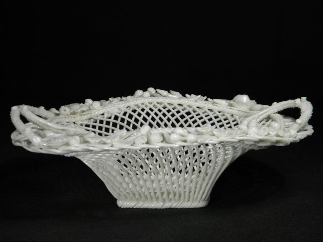 SMALL BELLEEK IRISH PORCELAIN BASKET: Small Beleek Irish porcelain handled basket, decorated around the rim with applied porcelain florals. Marked on base with stamped tag reading "Belleek". Condition: good, no chips or cracks, see images