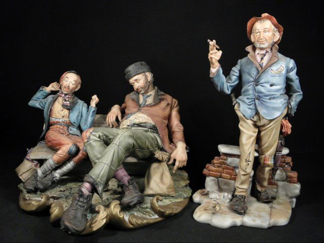TWO ITALIAN CAPODIMONTE PORCELAIN FIGURES BY BONALBERTI: Lot of two Italian Capodimonte porcelain figures by D. Bonalberti. Includes a single standing man smoking a cigar, and a figural group depicting two hobos sitting on a park bench. Both pieces are sign