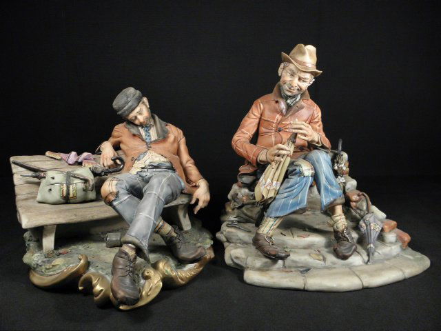 TWO CAPODIMONTE PORCELAIN FIGURES BY D. BONALBERTI: Lot of two Capodimonte Italian porcelain figures by D. Bonalberti. The first depicts a hobo falling asleep on a park bench, and the second depicts a hobo repairing an umbrella with a needle and thread