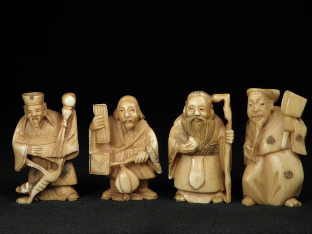 FOUR JAPANESE CARVED IVORY NETSUKE: Lot of four Japanese carved ivory netsuke. Includes four various standing men, each signed on base. Condition: minor discoloration from age as expected, see images. Each netsuke measures approximately