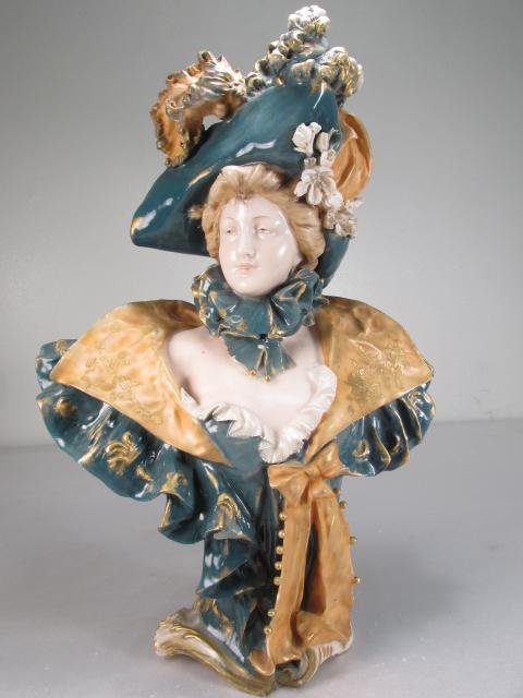 RIESSNER, STELLMACHER & KESSEL AMPHORA PORCELAIN BUST: Riessner, Stellmacher, & Kessel Amphora porcelain bust of a Victorian woman. Circa late 19th century. Incised on base "Amphora", and marked with red maker's mark "Turn-Teplitz Bohemia, RStK". Measures