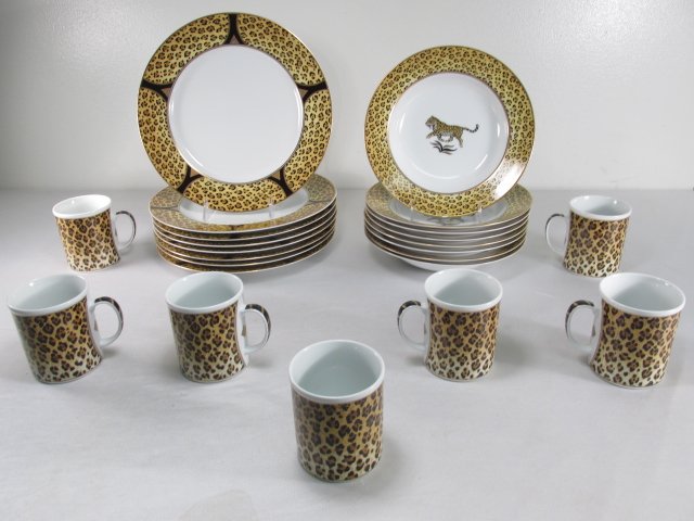 ASSORTED LYNN CHASE "AMAZONIAN JAGUAR" DINNERWARE: Lot of assorted porcelain dinnerware by Lynn Chase in the "Amazonian Jaguar" pattern. Each piece is decorated with 24K gold at the rim. Includes (80 10.9" plates, (8) 9.25" bowls, and (7) 3.65" tall m