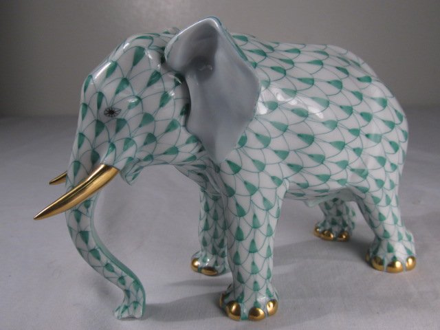 HEREND GREEN FISHNET DECORATED PORCELAIN ELEPHANT: Herend green fishnet decorated porcelain elephant m,measuring 3.5" tall x 5.3" long. Marked on base of feet with blue maker's mark and various factory numbers. Condition: good, no chips, cracks, or re