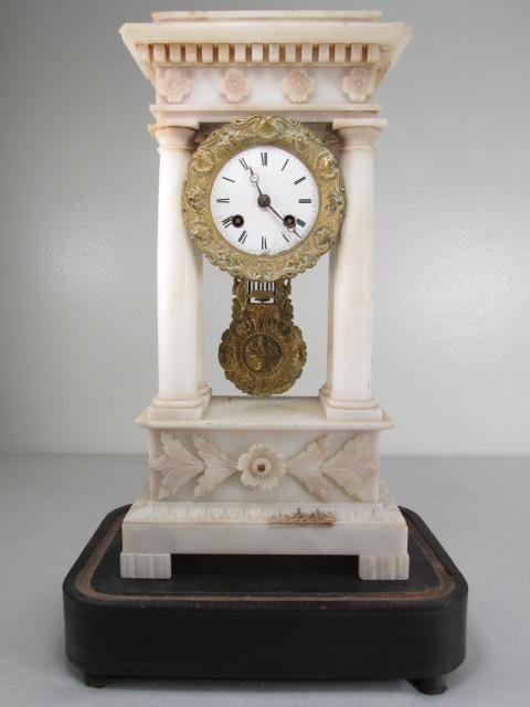 VINCENT & CIE WHITE ONYX CLOCK: French white onyx clock by Vincent & Cie. White enameled dial and face, with gilt bronze border. Original movement. Includes stand, but not glass dome. Condition: repair to top onyx panel, minor flake
