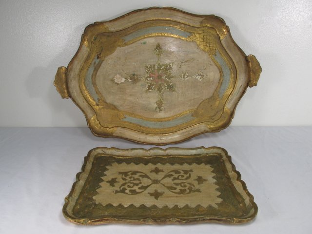 TWO ITALIANATE GILT WOOD SERVING TRAYS: Lot of two Italianate gilt wood serving trays. Both gilt with chased details. One measures 23.25" wide and the other 14.5" wide. Both stamped on base "Made in Italy". Condition: minor losses and signs