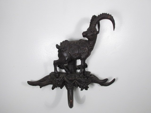 BLACK FOREST CARVED WALNUT MOUNTAIN GOAT HAT RACK: Black Forest carved dark walnut mountain goat form wall hat rack. Intricately carved details, with horn form hat hangers. Mounted on backside with hanging bracket. Condition: repair to both antlers, r