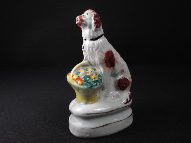 ENGLISH STAFFORDSHIRE PEARLWARE SPANIEL: English Staffordshire pearlware figure of a spaniel with a basket of fruit. Unmarked as to maker. Condition: minor losses to paint as expected, hairline running down the back of the dog's head and nec