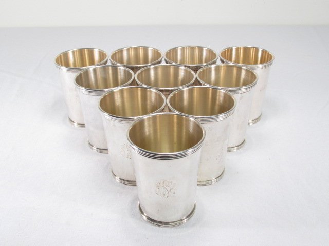 TEN INTERNATIONAL STERLING SILVER MINT JULEP CUPS: Lot of ten International sterling silver mint julep cups, each measuring 4" tall x 3" wide. Each monogrammed on side. Condition: good, two with very minor dings, see images. Total weight: 1310 grams o