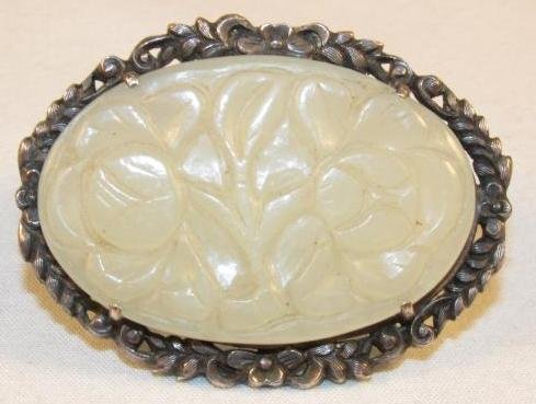 CHINESE SILVER & CARVED WHITE JADE BROOCH: Chinese silver and carved white jade floral brooch clip. Stamped on verso "CHINA" with two unknown maker's marks. Measures 1.65" wide x 1.25" tall. Weight: 12 g.