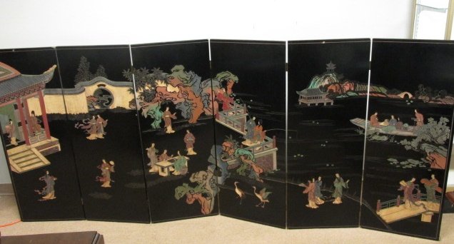 LARGE CHINESE SIX-PANEL COROMANDEL WALL HANGING SCREEN: A large 20th century Chinese six-panel Coromandel screen depicting a village scene with multiple figures. Hardware affixed on verso for hanging on the wall. Condition: minor dings/dents and losses to 