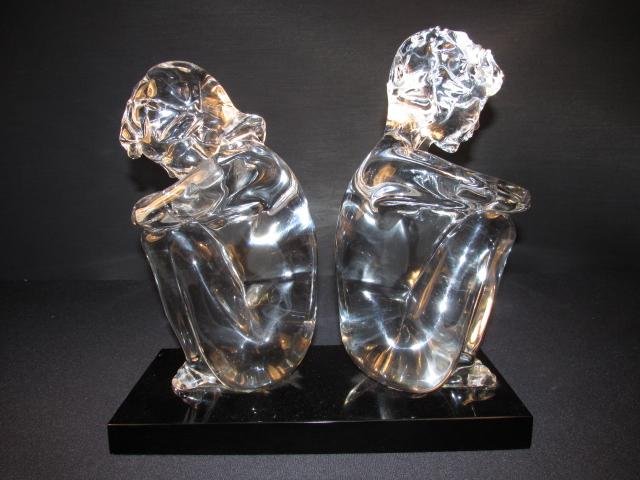 LOREDANO ROSIN MURANO GLASS SCULPTURE OF TWO CHILDREN: Loredano Rosin glass sculpture of two nude children sitting back to back on a black glass base. Murano, Italy. Signed on backside of base "Loredano Rosin". Condition: small repaired chip to upper righ