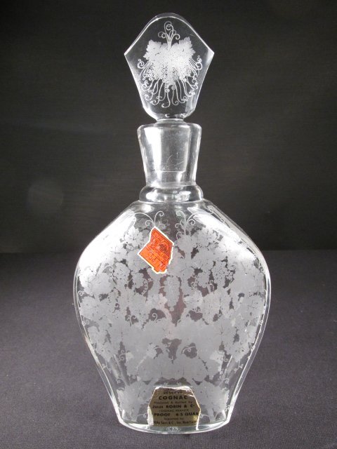 BACCARAT ETCHED GLASS COGNAC DECANTER: Baccarat etched glass cognac decanter. Retains tax label and "Jules Robin & Co" label. Original etched decanter. Acid etched on base with Baccarat logo. Condition: small chip to base, two tiny imperfe