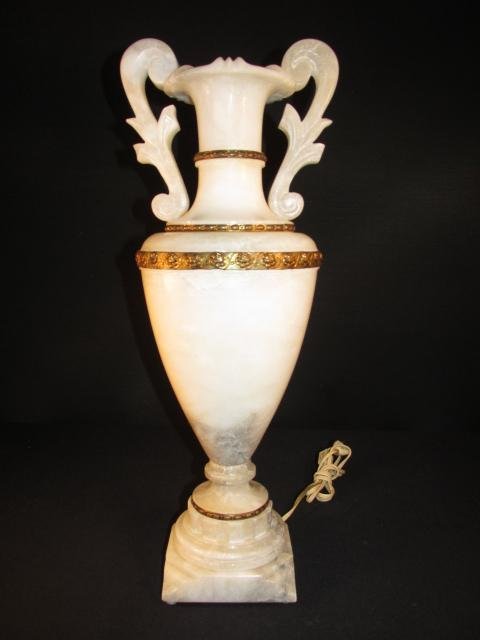 CARVED ALABASTER ROMAN TROPHY CUP STYLE LAMP: Carved alabaster inside lit "Roman trophy cup" style lamp with bands of floral embossed brass. Condition: good, no cracks or repairs, see images. Measures a total of 21" tall x 7" wide. Weight: 15 lbs