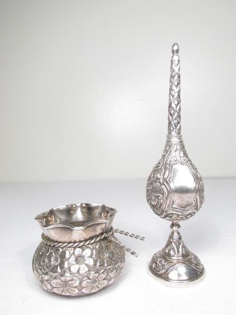 TWO PIECES REPOUSSE DECORATED SILVER: SPRINKLER & CUP: Lot of two pieces of repousse decorated silver. Includes a Middle Eastern rose water sprinkler, and a European silver bag form cup. Cup is stamped in interior "900 AK". Sprinkler is marked on edge of 
