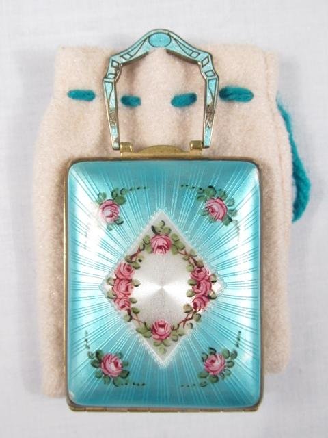 GUILLOCHE BLUE ENAMEL LADIES ART DECO COMPACT: A Art Deco Guilloche blue enamel ladies powder compact with moving handle. No noticeable marks on the case. Measurement is approx. 3.25" long x 1.75" wide. Inside - all in proper working order. Condit