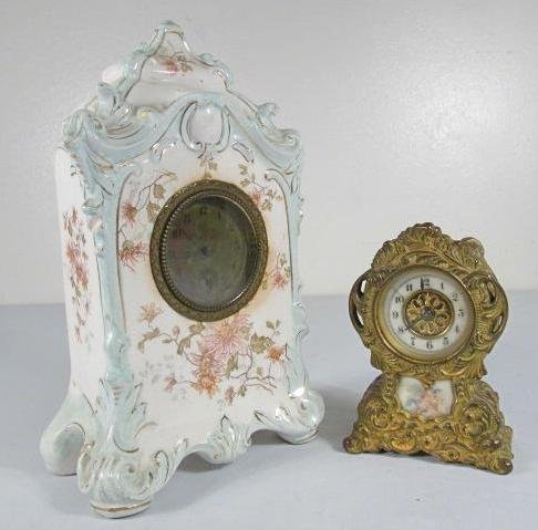 2 SMALL VICTORIAN CLOCKS: SMALL WATERBURY GILT,: Two small antique clocks: (1) Petite Waterbury Clock Co. heavy gilt molded case mantle shape 4-3/8" tall clock with a porcelain face and a hand painted image of two cherubs on porcelain in the clock b