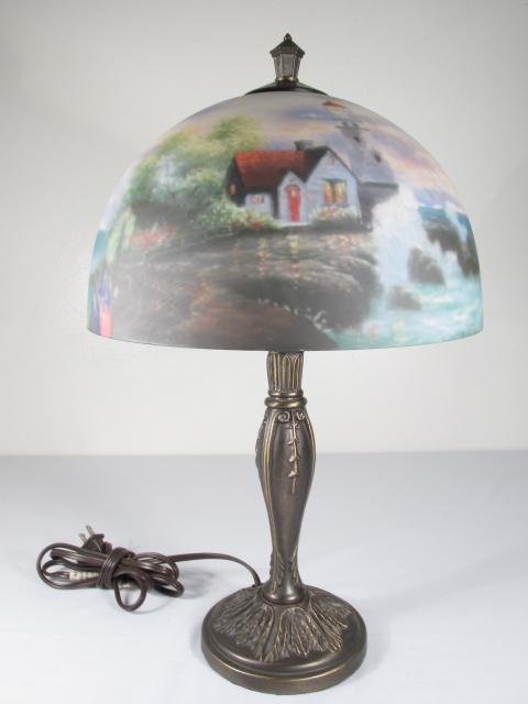THOMAS KINKADE REVERSE PAINTED SHADE TABLE LAMP: Thomas Kinkade reverse painted shade on metal table lamp base. Condition: Good, see images. Measurements: Lamp + shade 18.5", Shade bottom diameter is approx. 12". Shipping weight is approx. 7 lbs.