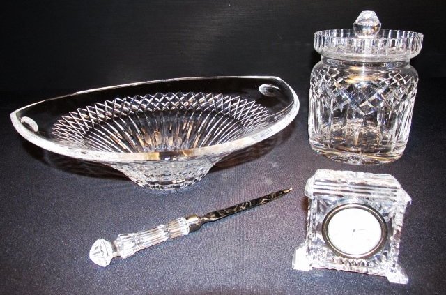 ASSORTED LOT OF WATERFORD CRYSTAL 'LISMORE' PATTERN: Assorted group of Waterford crystal including a lidded biscuit jar and large oval bowl in the Lismore pattern plus a Waterford small clock in the Pavilion pattern, and a letter opener. Condition: Good