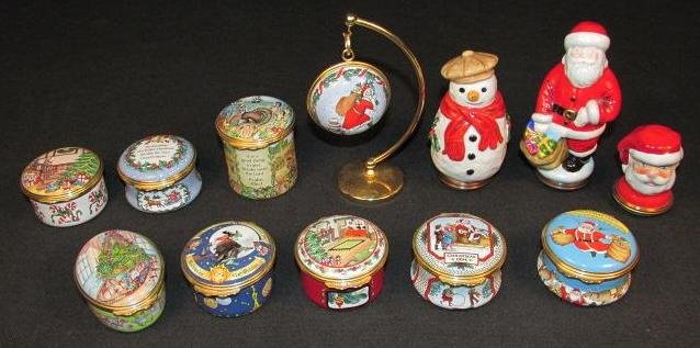 TWELVE HALCYON DAYS HOLIDAY THEMED ENAMEL BOXES: Lot of twelve Halcyon Days holiday themed enamel boxes. Includes Santa Claus, bust of Santa Claus, a snowman, six additional Christmas themed boxes, a Christmas ornament with stand, a Thanksgiving the