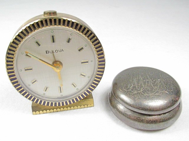 STERLING PILL BOX & BULOVA VANITY CLOCK: A monogrammed sterling silver pill box - 20 grams weight and also a made in Germany BULOVA vanity wind-up clock. Condition: As-is, estate found, condition, see images. Shipping weight is approx. under