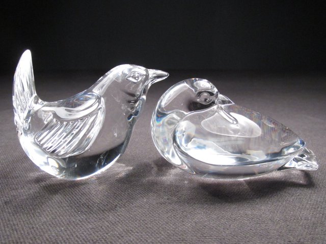 TWO STEUBEN CRYSTAL HAND COOLERS: WREN & DOVE: Lot of two Steuben crystal hand coolers. Includes a 2.25" tall Wren (designed by Lloyd Atkins, 1990), and a 1.75" tall Dove (designed by Lloyd Atkins 1997). Dove is signed under wing and Wren is signe