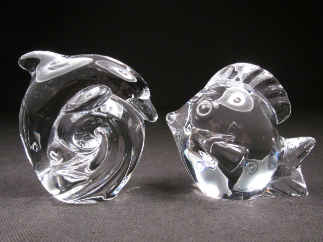 TWO STEUBEN CRYSTAL HAND COOLERS: FISH & DOLPHIN: Two Steuben crystal hand coolers. Includes a 2.5" tall Dolphin, and a 2.5" tall Fish. Both pieces are signed on base "Steuben". Condition: tiny flake to base edge of fish, see images. Weight: 1 lb.