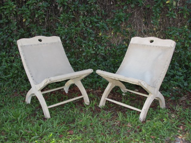 PAIR WILLIAM SPRATLING BUTAQUE CHAIRS: Pair of primitive style Butaque chairs by William Spratling. Painted in a cream color and with cream colored upholstery. Each chair is stamped on back with "WS" mark followed by "Taxco". Condition: he