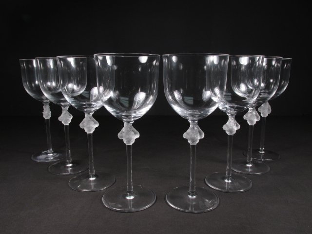 EIGHT LALIQUE "ROXANE" CLEAR GLASS STEMS: Lot of eight Lalique clear and frosted glass stems in the "Roxane" or "Roxanne" pattern. Each stem measures 8.4" tall and is signed "Lalique France" on base. Condition: small flake to rim of one stem,