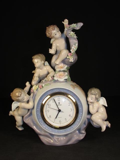 LLADRO "ANGELIC TIME" PORCELAIN MANTEL CLOCK #5973: Lladro "Angelic Time" Spanish porcelain mantel clock, model number 5973. Signed on base with blue maker's mark, and incised with number 5973. Condition: good, no losses or flakes at all, clock has som