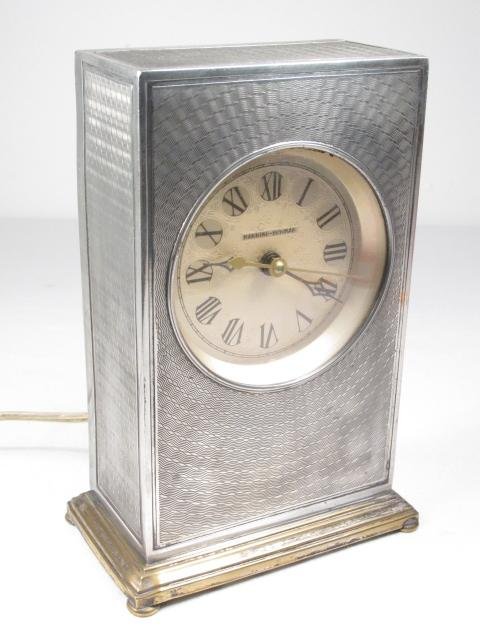 MANNING BOWMAN ART DECO SILVER PLATED DESK CLOCK: Manning Bowman Art Deco silver plated desk. clock. Measures 7.5" tall x 5" wide x 3" deep. Convex glass crystal with a roman numeral dial. Marked "Manning Bowman" on face. Condition: clock does not ru