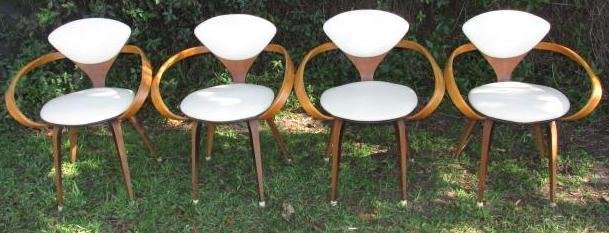 FOUR PLYCRAFT MID CENTURY MODERN "PRETZEL" CHAIRS: Lot of four mid century modern bent plywood "Pretzel" chairs designed by Norman Cherner. All with white leather seats and back cushions. Condition: minor signs of age to each chair, a few small scuffs