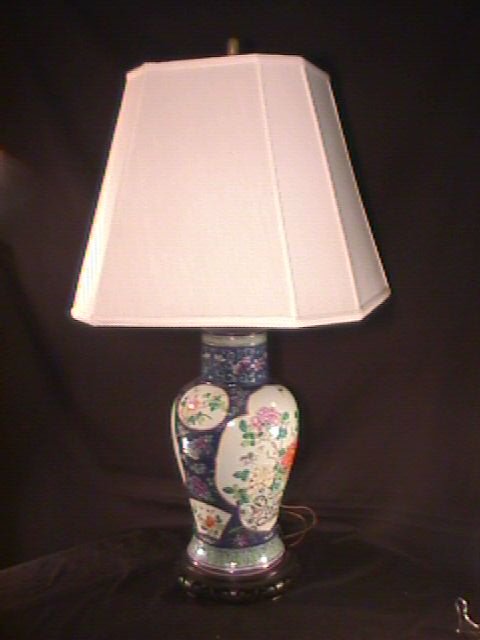 HAND PAINTED FLORAL ORIENTAL TABLE LAMP WOOD BASE: HAND PAINTED FLORAL ORIENTAL TABLE LAMP WOOD BASE Measures 34" high x 8 1/2: wide. Some chips in wooden base. Good condition. Not antique.