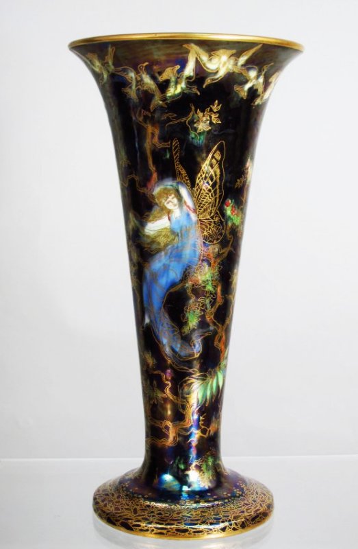 WEDGWOOD FAIRYLAND LUSTRE VASE BY DAISY MAKEIG-JONES: A fairyland lustre vase by Daisy Makeig Jones for Wedgwood, circa 1920. Fairyland scene intricately depicts the butterfly lady or woman. Measures 9.5" tall x 4.75" wide at rim, and 3.8" wide at base. 