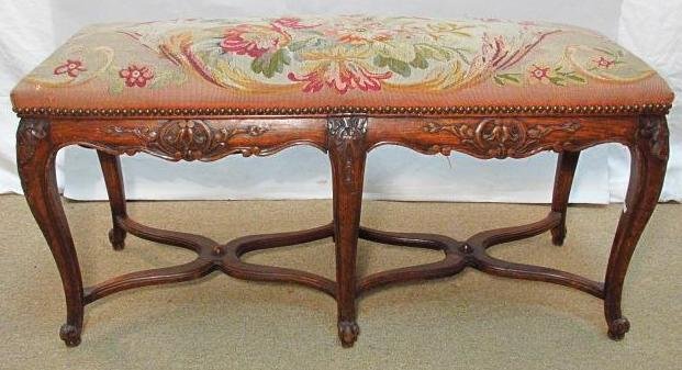 EARLY 19TH C FRENCH CARVED WOOD BENCH W/ NEEDLEPOINT: Early 19th century French carved wood bench with a floral Aubusson style needlepoint upholstery. Beautiful carved floral details on the frame. Condition: generally good, some reinforcements and minor