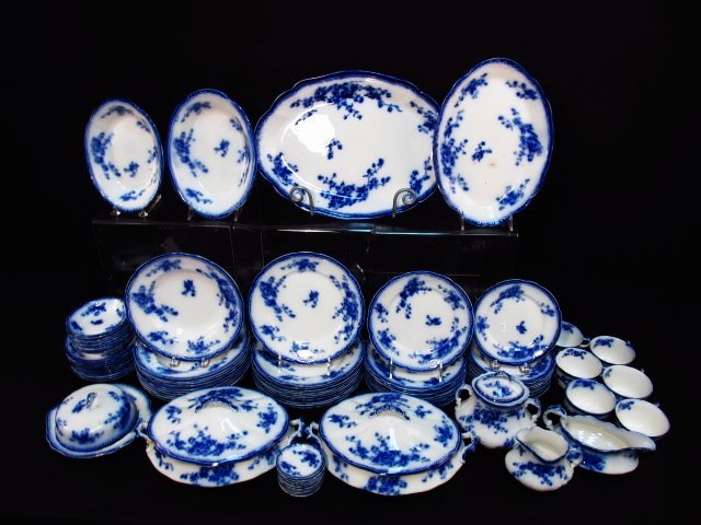 W.H. GRINDLEY "MARECHAL NEIL" FLOW BLUE PORCELAIN: 80: Set of W.H. Grindley flow blue porcelain dinnerware in the "Marechal Neil" pattern. Includes (11) 9" plates (hairline to one, glaze skip to one, chip to one), (11) 8" plates (four have chips), (10) 6"