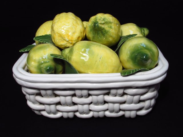 ITALIAN CERAMIC BASKET OF LEMONS CENTERPIECE: Italian ceramic centerpiece in the form of a basket of lemons. Marked on base. Measures 6.5" tall x 9.5" wide. Condition: good, see images. Weight: 6 lbs.