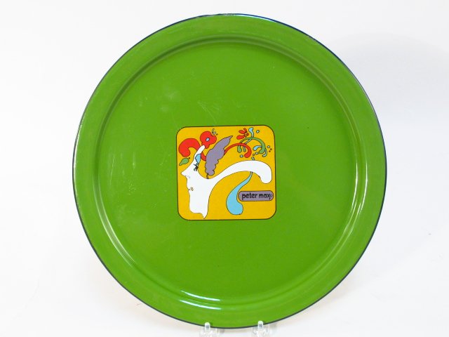 PETER MAX POP ART CIRCULAR GREEN ENAMELED TRAY: Peter Max pop art psychedelic style green enameled circular tray measuring 13.25" in diameter. Remains of a silver sticker on verso. Condition: a few small chips to rim, see images. Weight: 1.5 lbs.