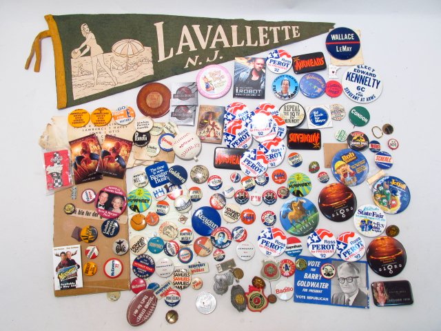 POLITICAL CAMPAIGN PINS, BUTTONS & MORE: A large variety of 1950's and 1960's political campaign buttons: Goldwater, Kennedy, McGovern and more. Also included in this lot are some various kids police badges, and a flet pennant. Condition: Es