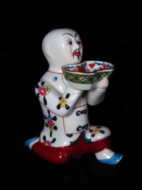 HEREND 4.5" PORCELAIN KNEELING CHINESE MAN SALT CELLAR: Herend 4.5" tall porcelain salt cellar in the form of a kneeling Chinese man. Marked and incised on base. Condition: good, no chips or cracks, see images. Weight: .3 lbs.