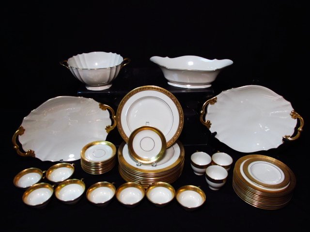 ASSORTED LENOX GOLD BANDED PORCELAIN DINNERWARE: 51 PCS: Lot of assorted Lenox Ivory colored gold banded porcelain dinnerware. Includes 51 total pieces: dinner plates, salad plates, cups, saucers, handled trays, bowls, and more. Condition: oval serving bowl