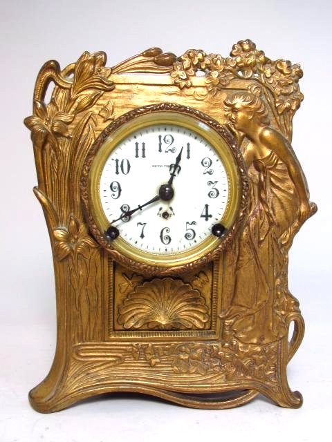 LARGE SETH THOMAS ART NOUVEAU MANTEL CLOCK: A large Seth Thomas Art Nouveau mantel clock measuring 11" tall x 8.3" wide and 4.5" deep. Original beveled glass crystal with Arabic numeral dial. No key. Condition: minor signs of wear and age, incl