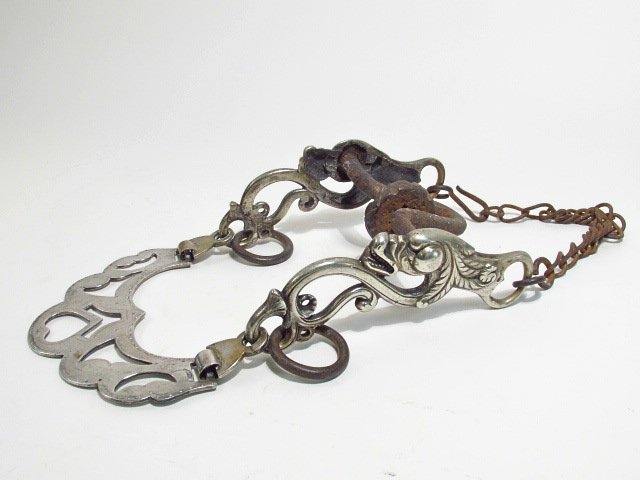 ANTIQUE HAND WROUGHT MEXICAN SILVER HORSE BIT: Antique Mexican silver and hand wrought iron horse bit with figural elements. Condition: patina and tarnishing to finish in areas, see images. Marked by maker "V. Mello". Measures a total of 6.5" wide