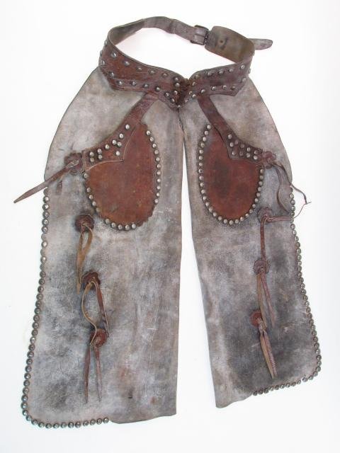 VINTAGE WESTERN AMERICANA HANDMADE LEATHER CHAPS: Vintage Western Americana handmade leather chaps. Measures a total of 35.5" long. Condition: signs of wear and age, see images. Weight: approx. 8 lbs.